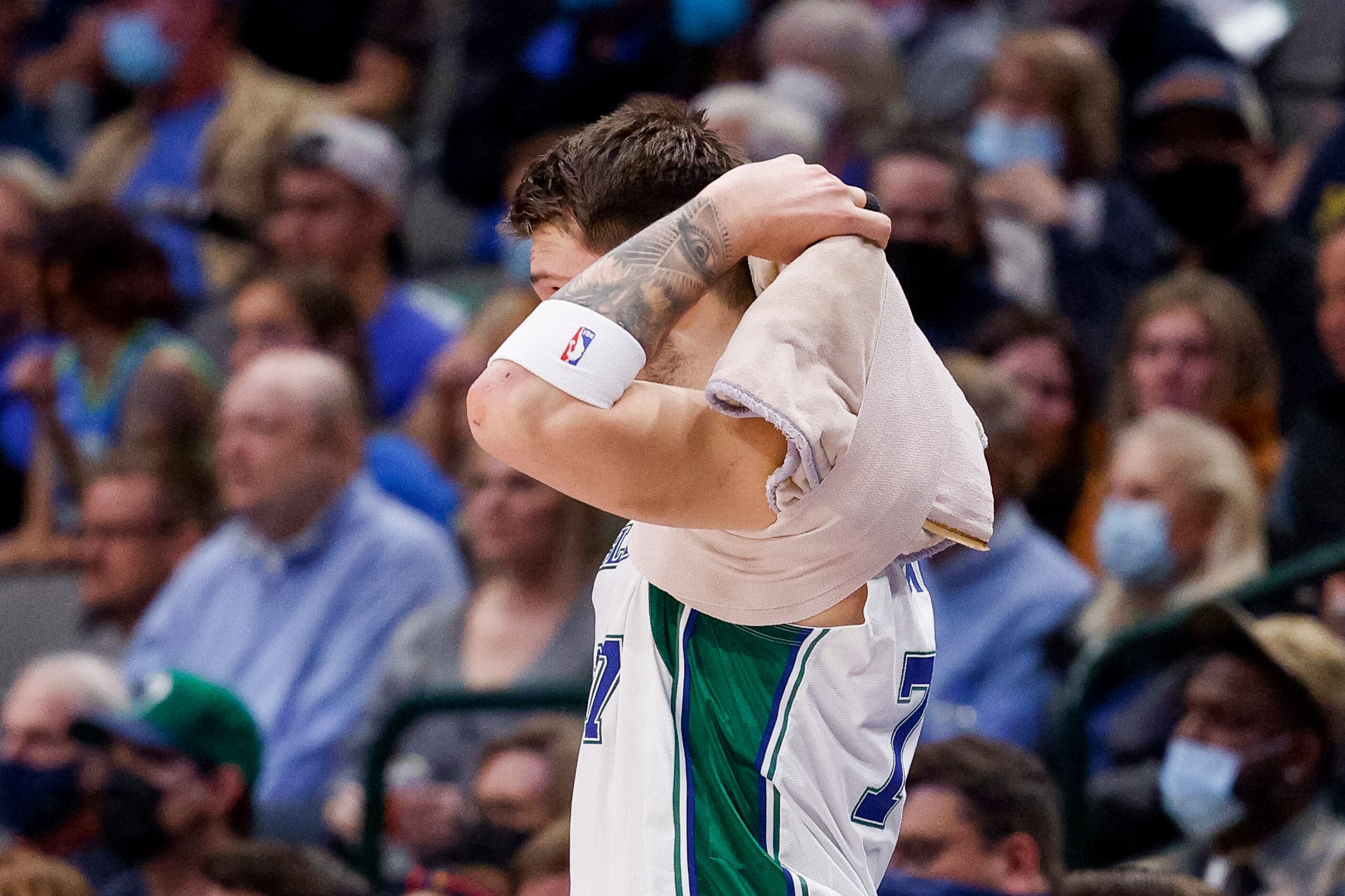 Dallas Mavericks guard Luka Doncic (77) removes a heat pack before entering the game during...