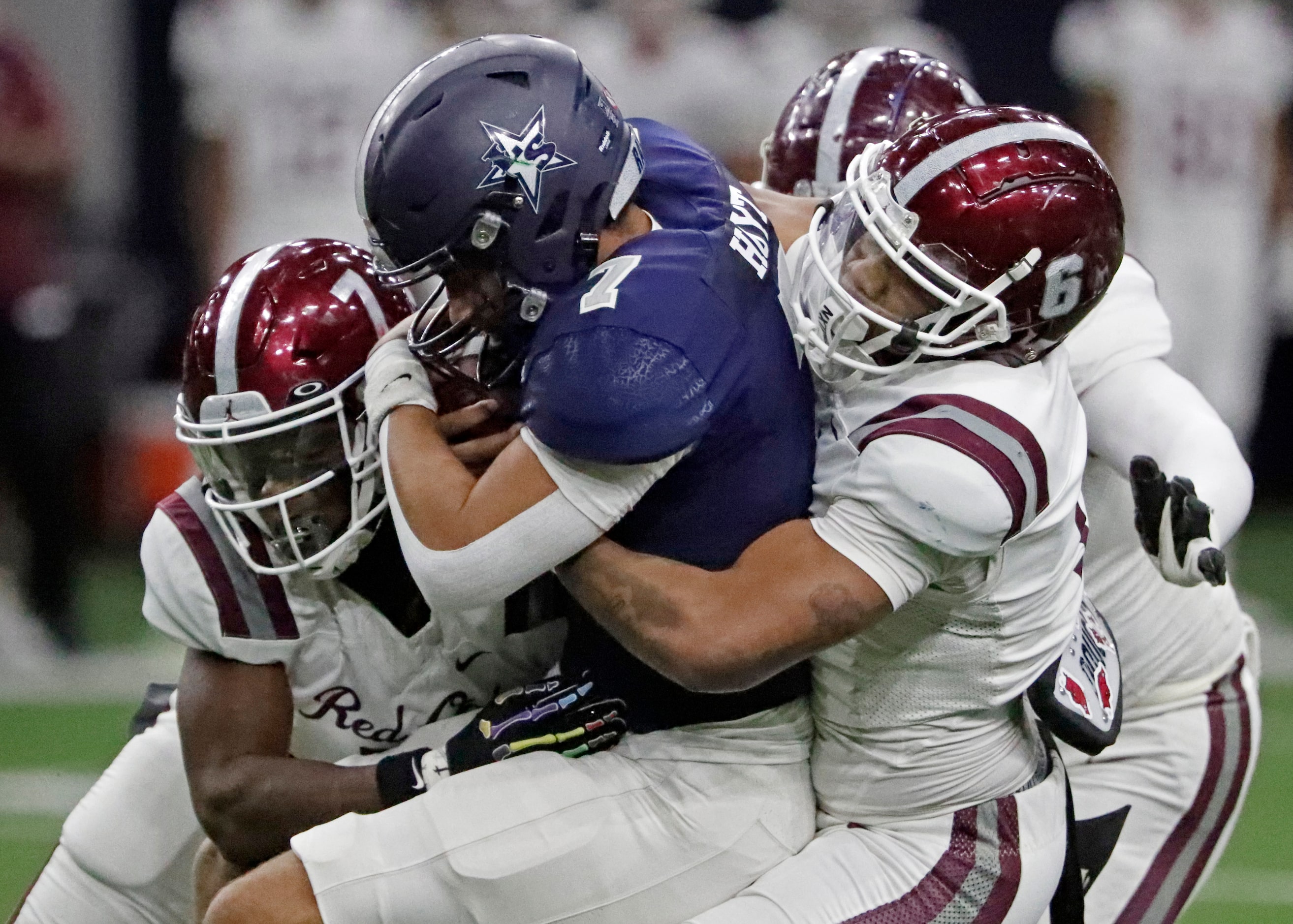 Lone Star High School quarterback Karece Hoyt (7) is wrapped up by Red Oak High School...