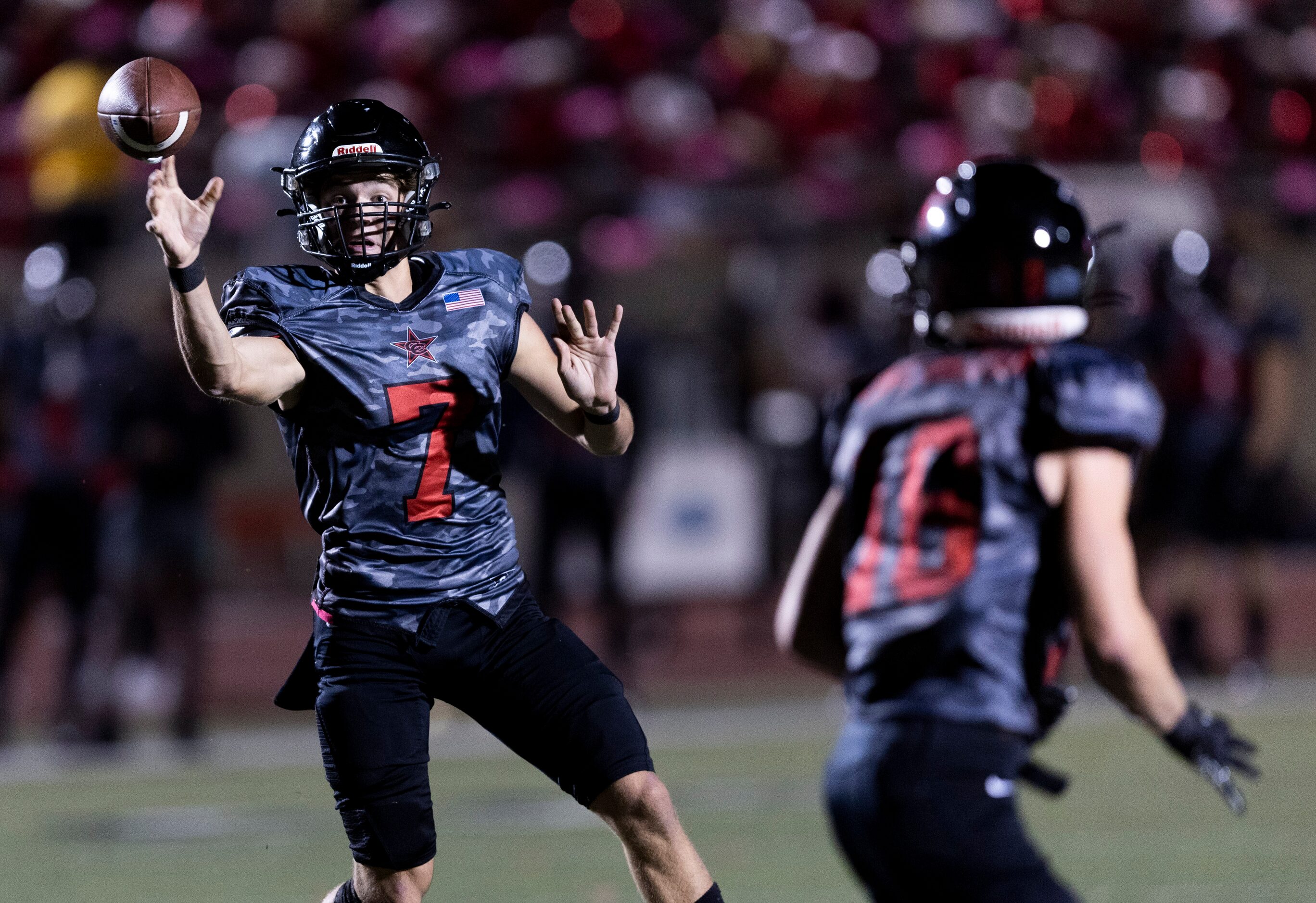 Coppell senior quarterback Jack Fishpaw (7) throws to senior wide receiver Zack Darkoch (18)...