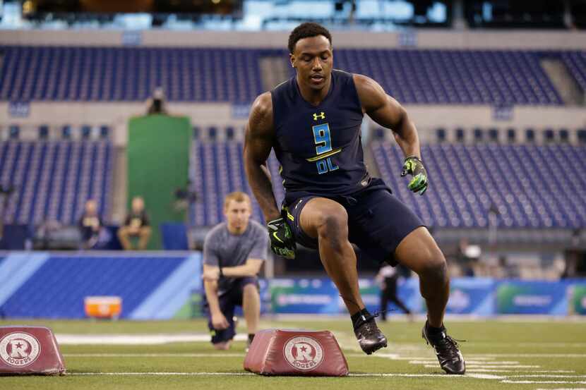 Michigan defensive end Taco Charlton runs a drill at the NFL football scouting combine in...