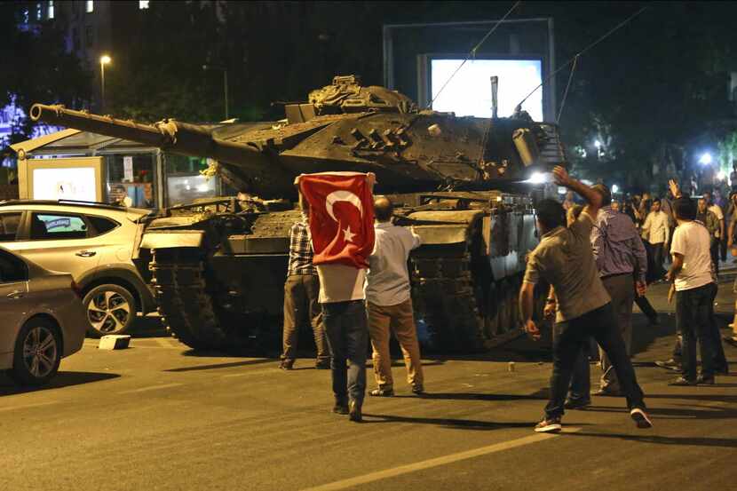 A tank moves into position as Turkish people attempt to stop them, in Ankara, Turkey, early...