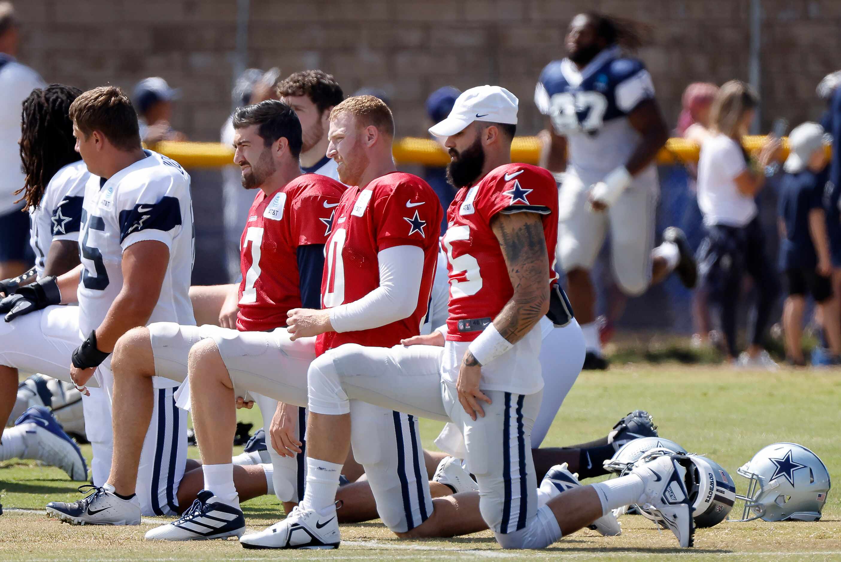 Dallas Cowboys backup quarterbacks (from right) Will Grier (15), Cooper Rush (10) and Ben...