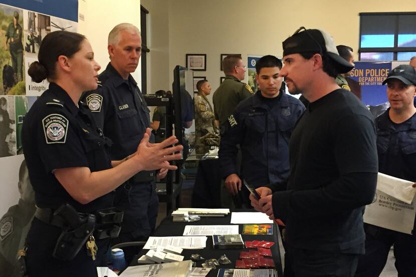 U.S. Customs and Border Protection recruiter Kelly Ursu talks with Michael Hamilton, a...