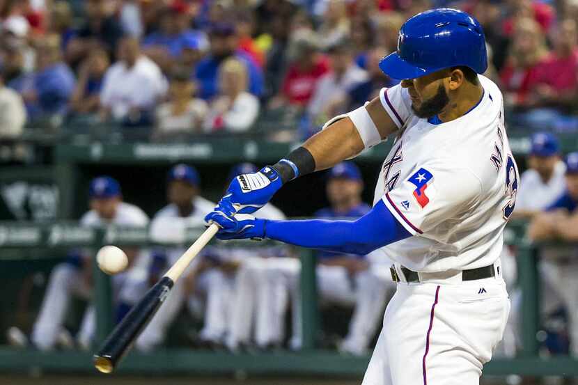 Texas Rangers right fielder Nomar Mazara drives in a run with a single in the third inning ...