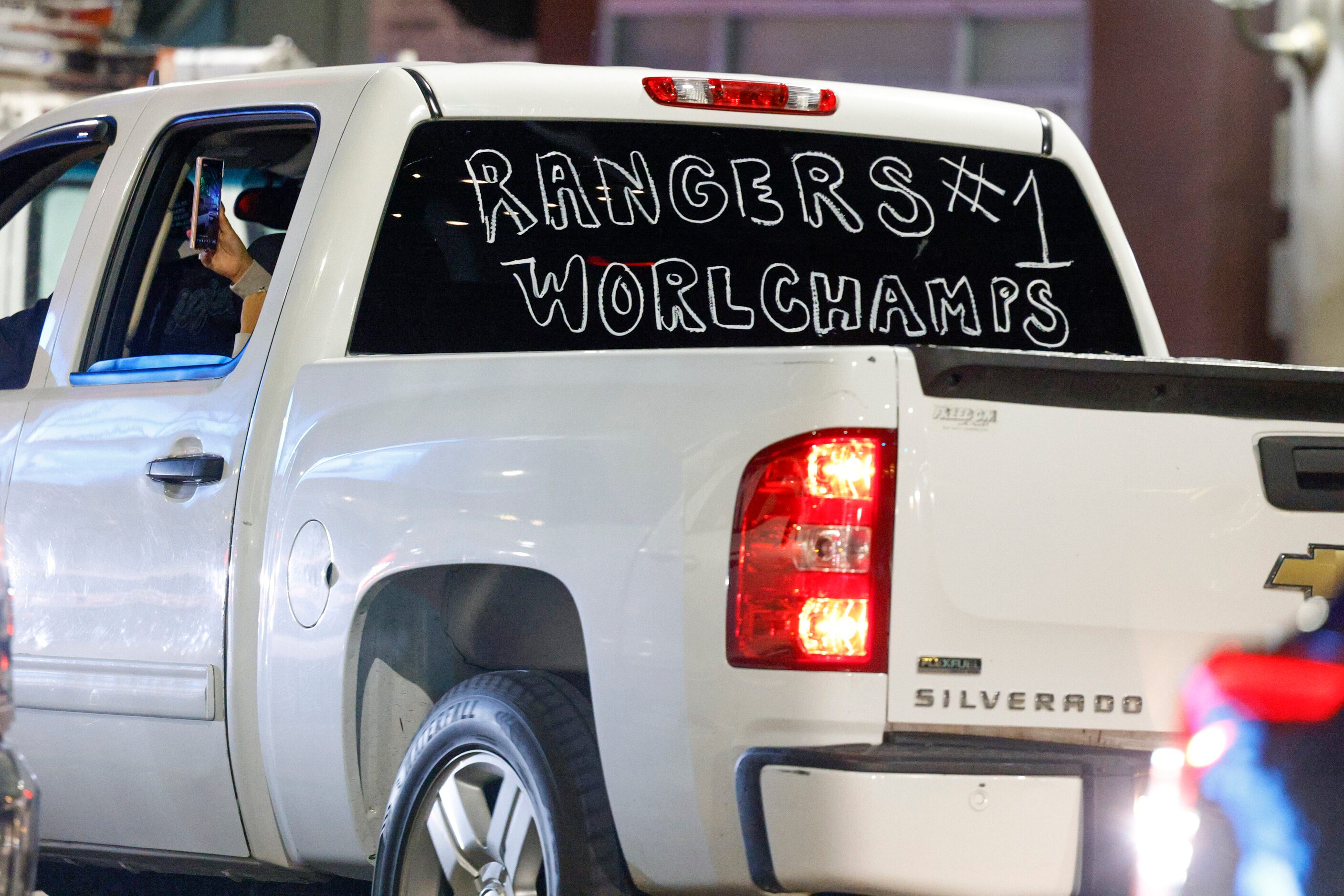 A truck drives along Main Street celebrating the Texas Rangers World Series championship,...