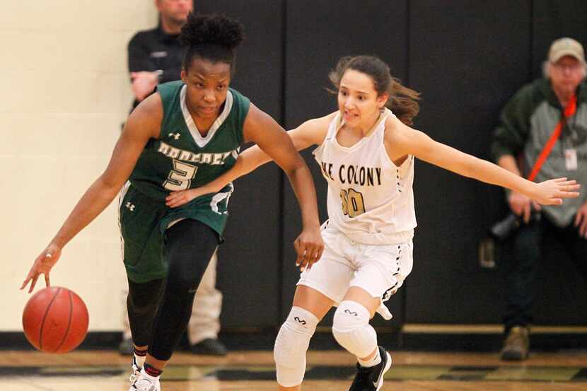 Proper post Jordyn Oliver dribbles down the court while defended by The Colony gaurd Hannah...