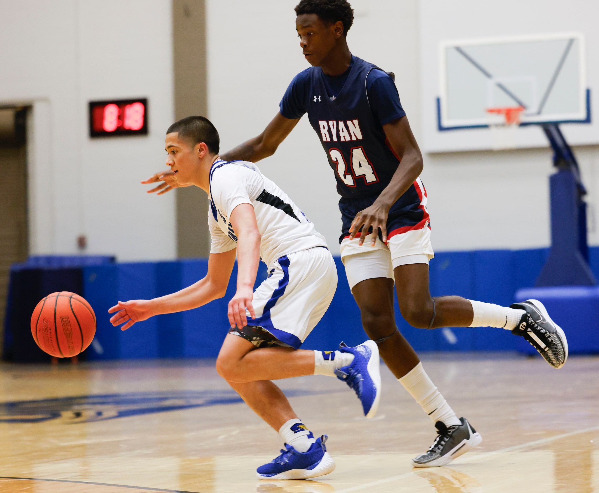 Mansfield Summit’s Theo Brannan (left) dribbles past Denton Ryan’s Xavier Hiler during the...