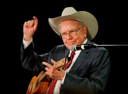  Warren Buffett, the CEO of Berkshire Hathaway, plays the ukelele with Susie Blumkin, the...