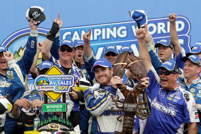 Brian Vickers celebrates with a giant lobster and his crew in victory lane after winning the...
