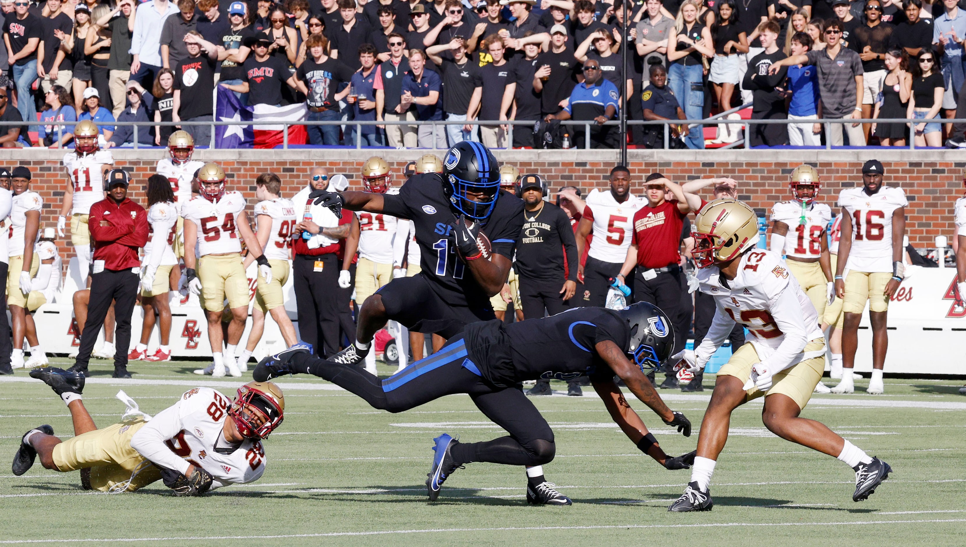 SMU running back LJ Johnson Jr. (11) keeps the ball away from Boston College defensive back...