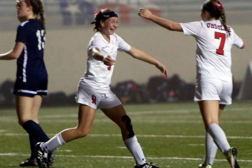 Ursuline's Lindsey Hover (5) is all smiles as she celebrates her second half goal with...