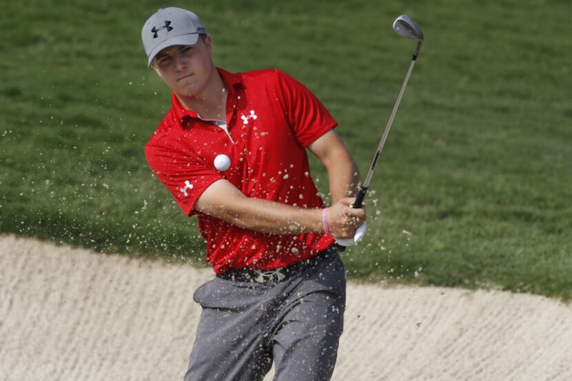 Jordan Spieth hits from a sand trap on the 1st hole during the third round of the HP Byron...