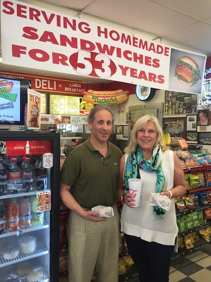 Randy and Paige Flink hold their fresh-off-the-grill burgers at Parkit Market.
The...