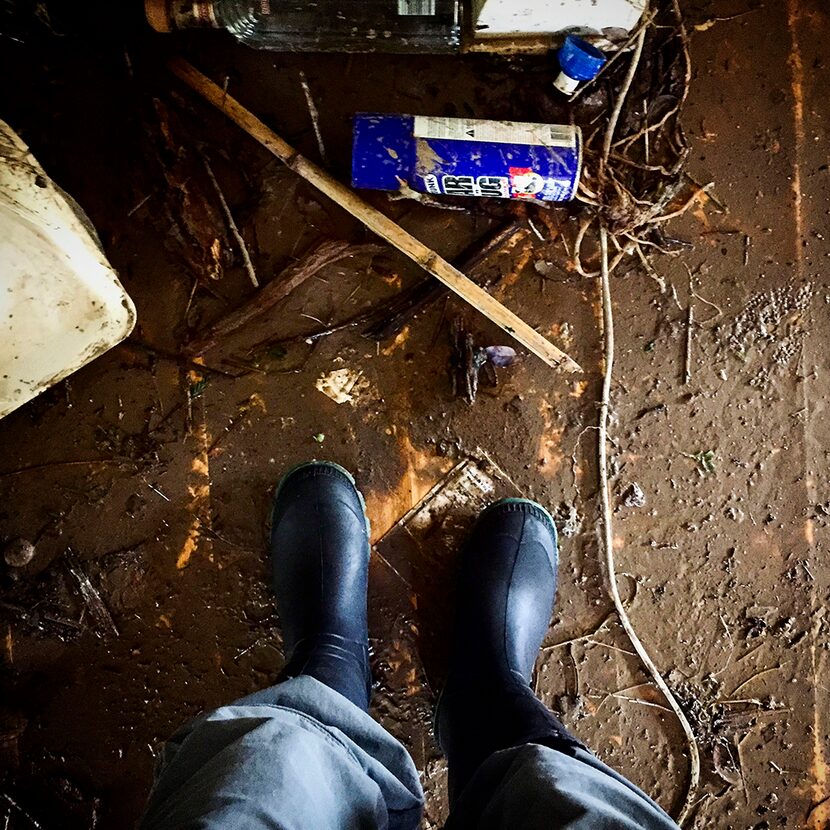  My mud boots on the flooded kitchen floor of the home of Larry Fick and Cynthia Marion on...