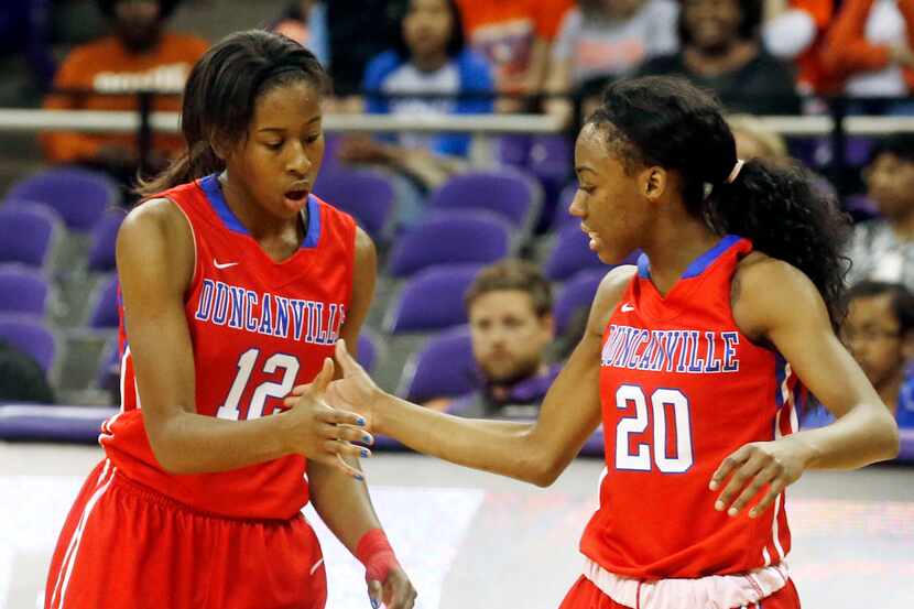 Duncanville's  Ariel Atkins (12) is congratulated by Tasia Foman (20) after Atkins made a...