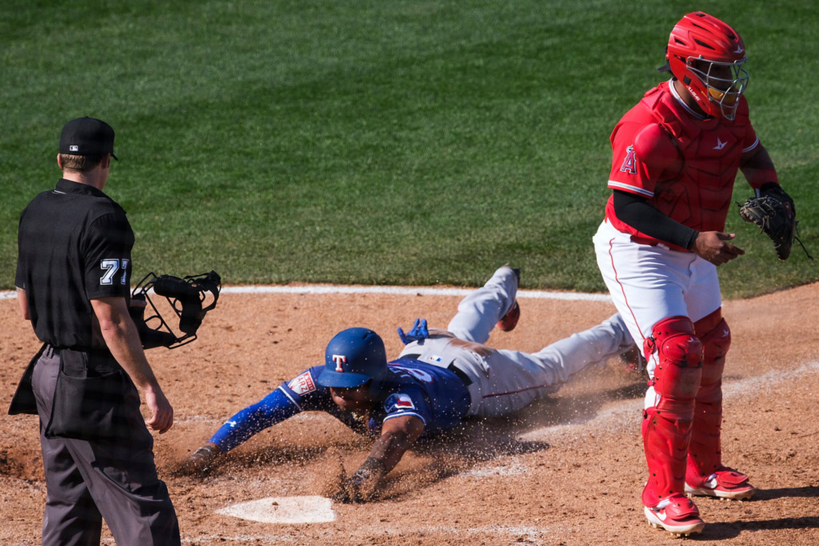 Texas Rangers infielder Andy Ibânez scores past sacrifice fly by Danny Santana during the...