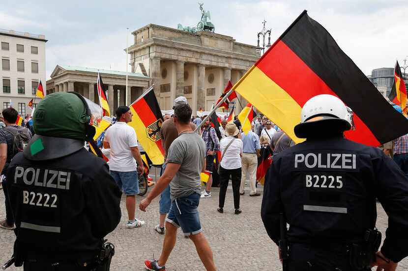 Supporters of German AfD wave flags in front of the Brandenburg Gate in Berlin, Germany,...
