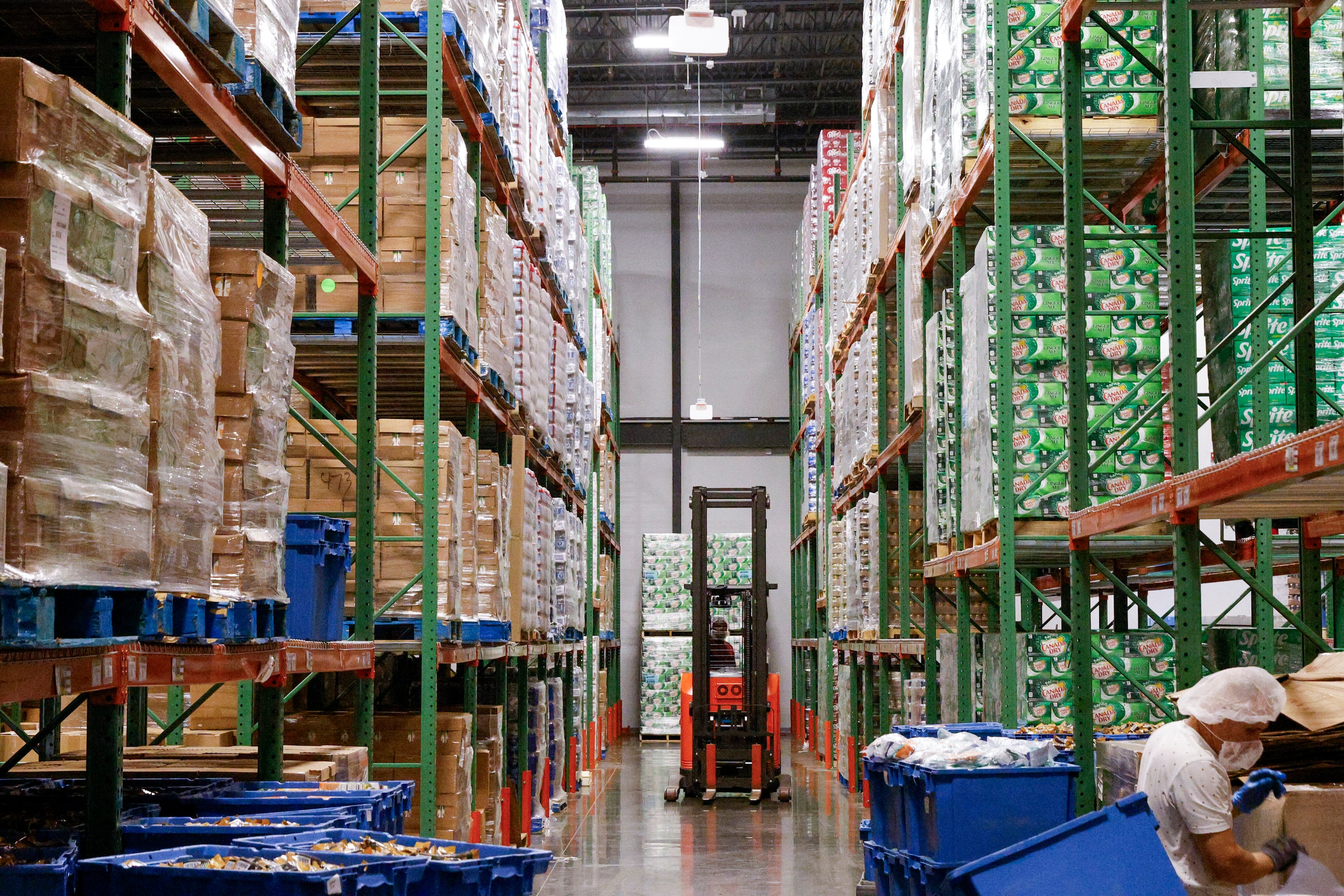 A warehouse at American Airlines catering kitchen stores pallets of beverages and food,...