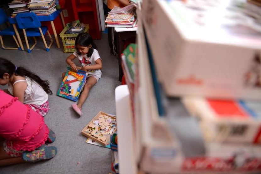 
Kelly Melendez, 4, opens up a game at the Bea's Kids facility at Cooks Creek Apartments in...