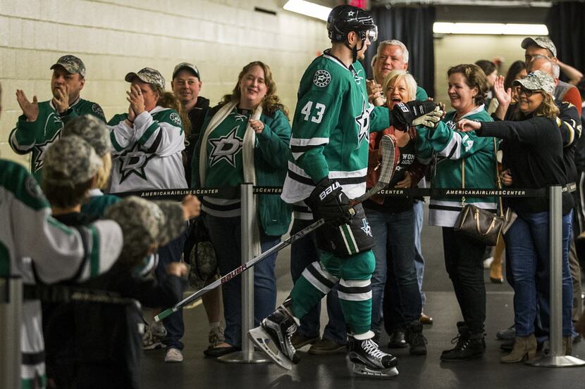 Dallas Stars right wing Valeri Nichushkin (43) high fives fans before taking the ice to face...