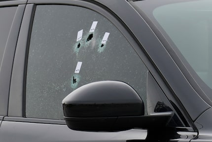 Bullet holes are seen in a car window after Harris County Deputy Constable Maher Husseini...