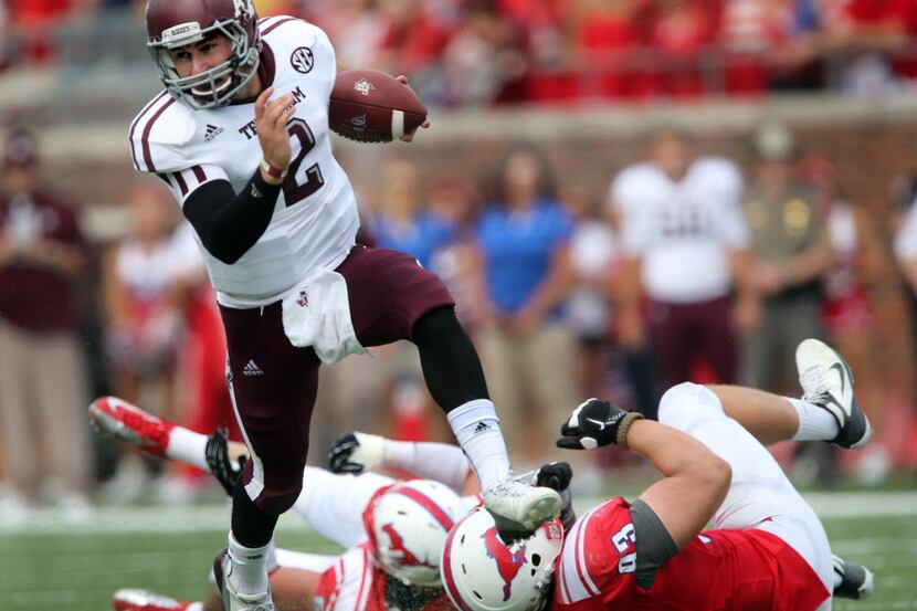 Texas A&M quarterback Johnny Manziel (2) breaks free i in the secondary on his way to a...