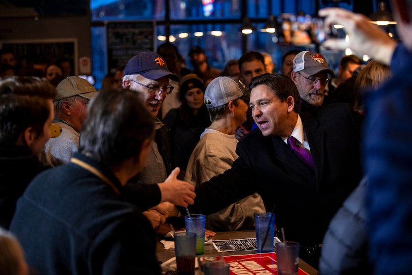 Republican presidential candidate Florida Gov. Ron DeSantis, right, greets supporters...