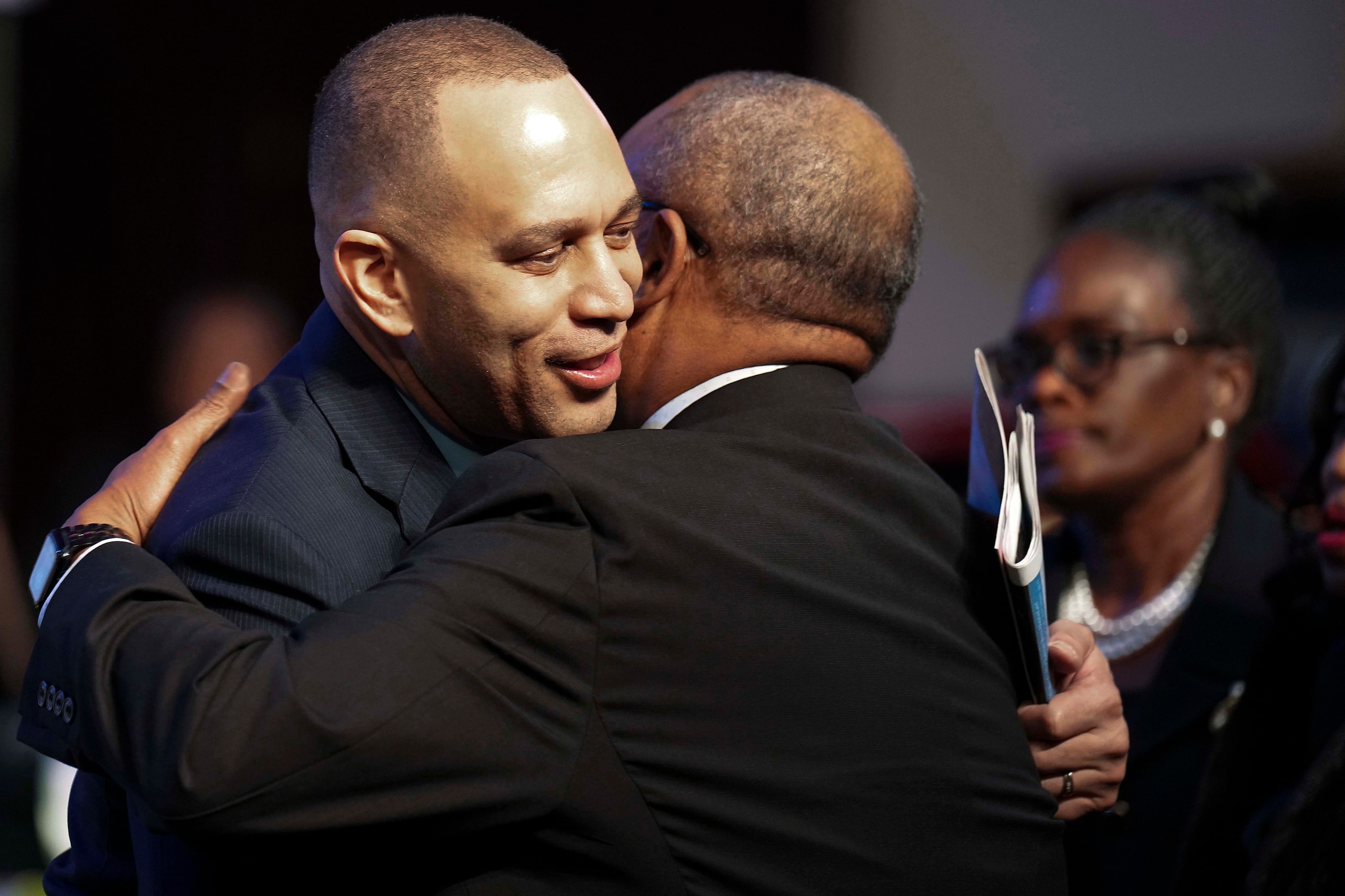 House Minority Leader Hakeem Jeffries, D-NY, hugs Kirk Johnson, son of for former U.S. Rep....