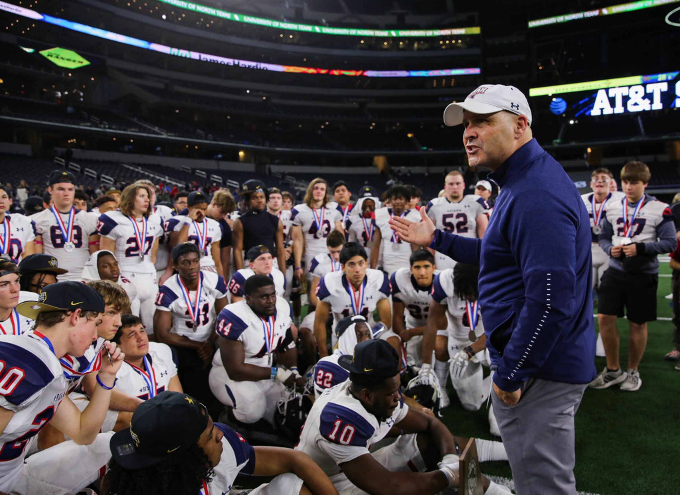 Denton Ryan's head coach Dave Henigan speaks to his team after losing a Class 5A Division I...
