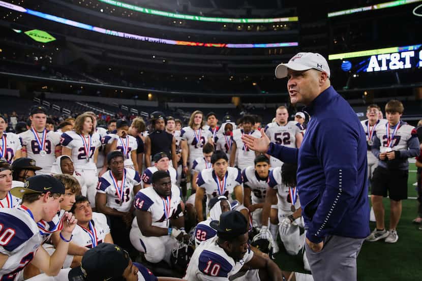 Denton Ryan's head coach Dave Henigan speaks to his team after losing a Class 5A Division I...