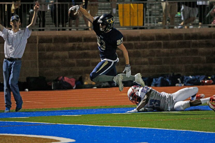 Jesuit's John Wunderlick (23) scores a touchdown in front of Skyline's Demorise Dantzler...