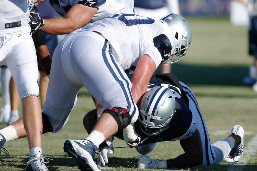 Dallas Cowboys offensive tackle Dan Skipper (60) helps Dallas Cowboys defensive end Taco...