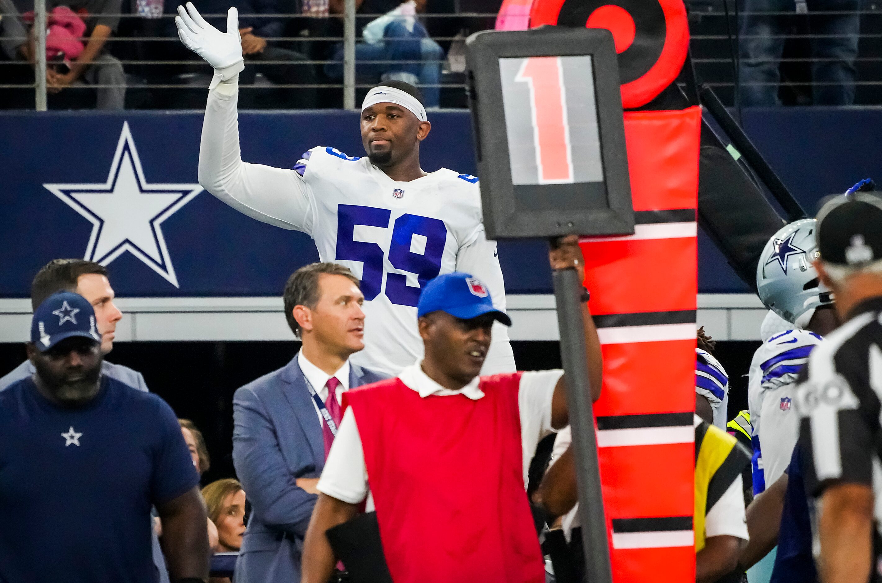 Dallas Cowboys defensive end Chauncey Golston (59) waves toward the Carolina Panthers bench...