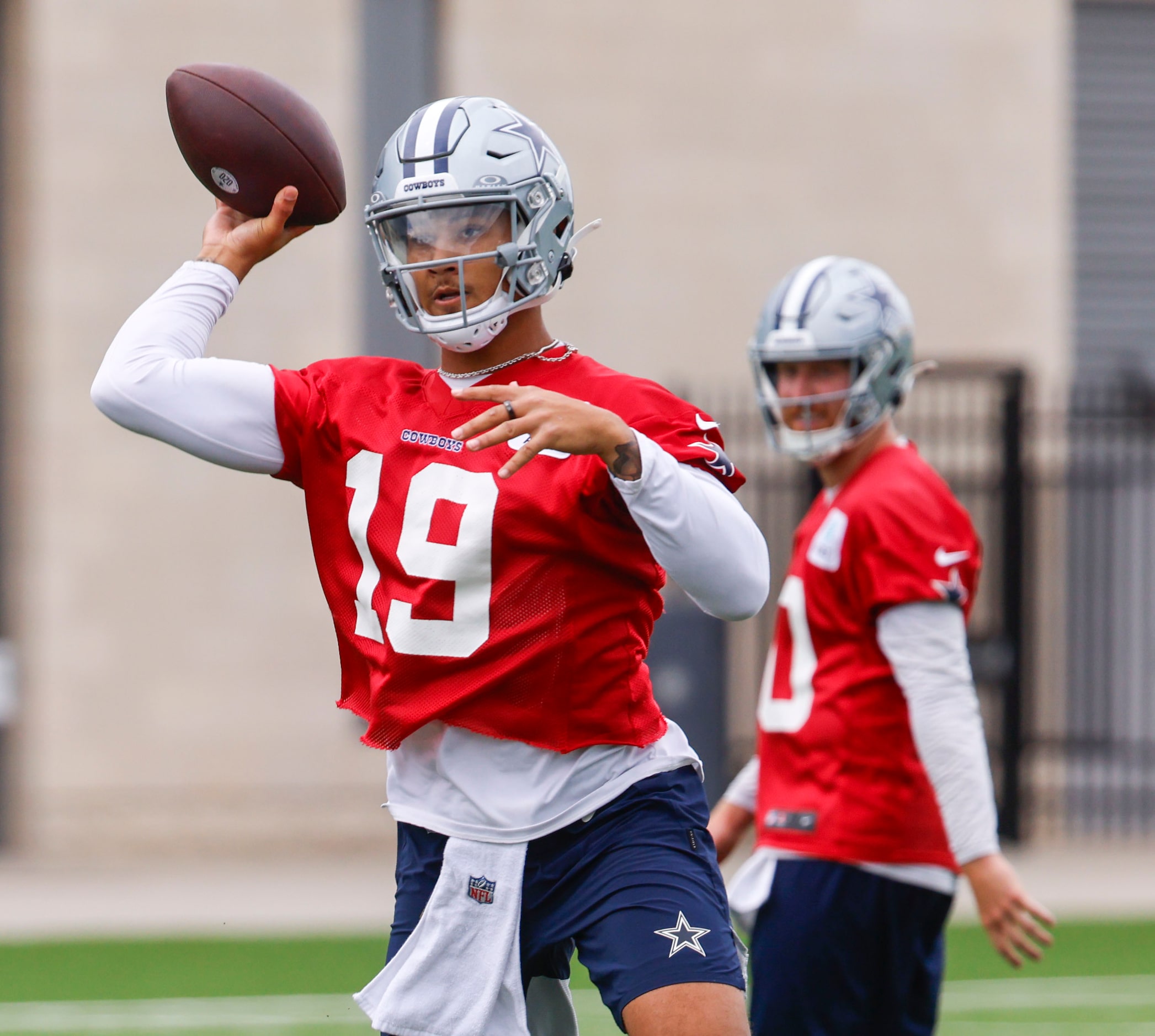 Dallas Cowboys quarterback Trey Lance (19) throws as the takes part in a drill during a team...