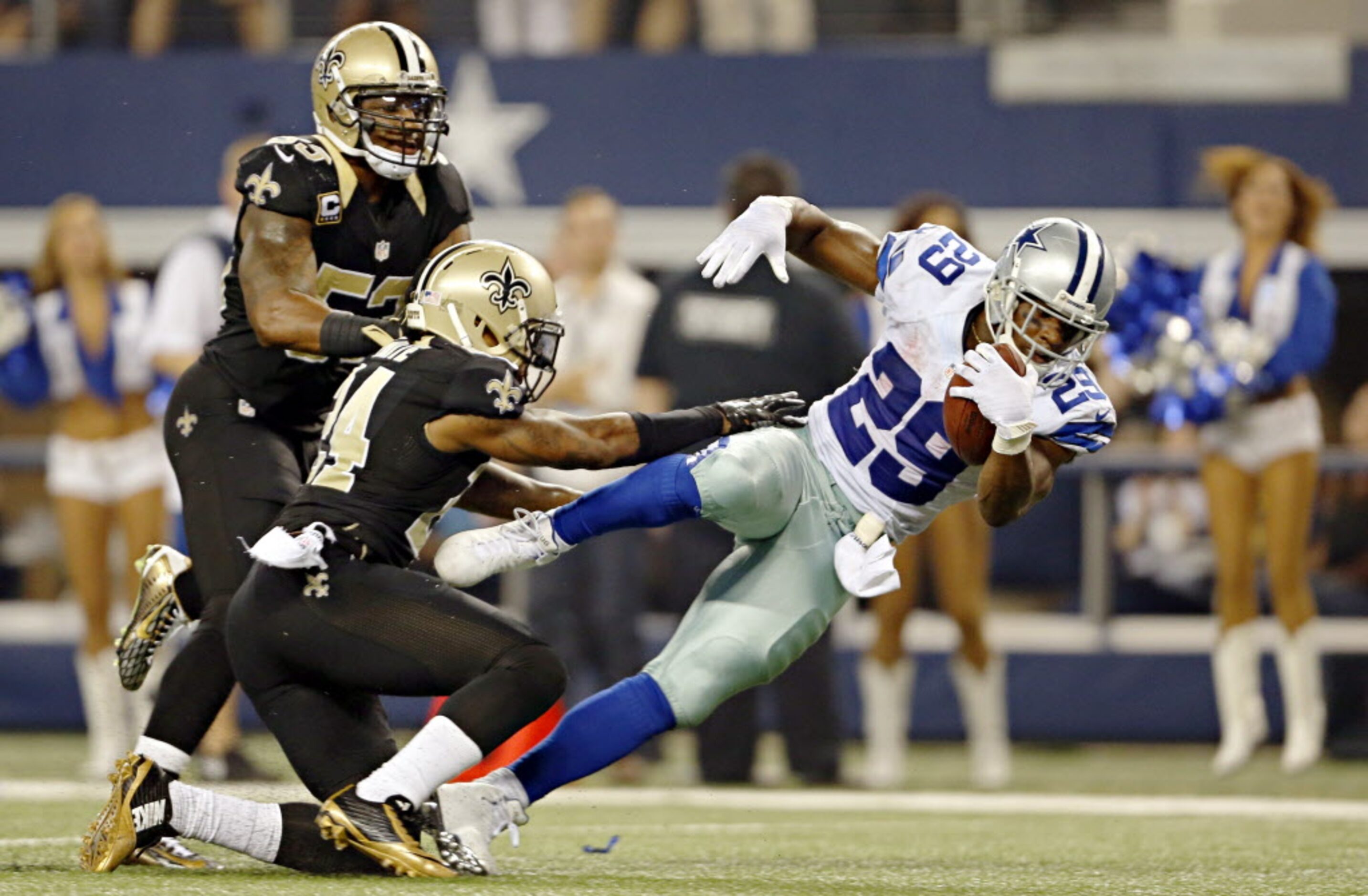 New Orleans Saints cornerback Corey White (24) shoves Dallas Cowboys running back DeMarco...