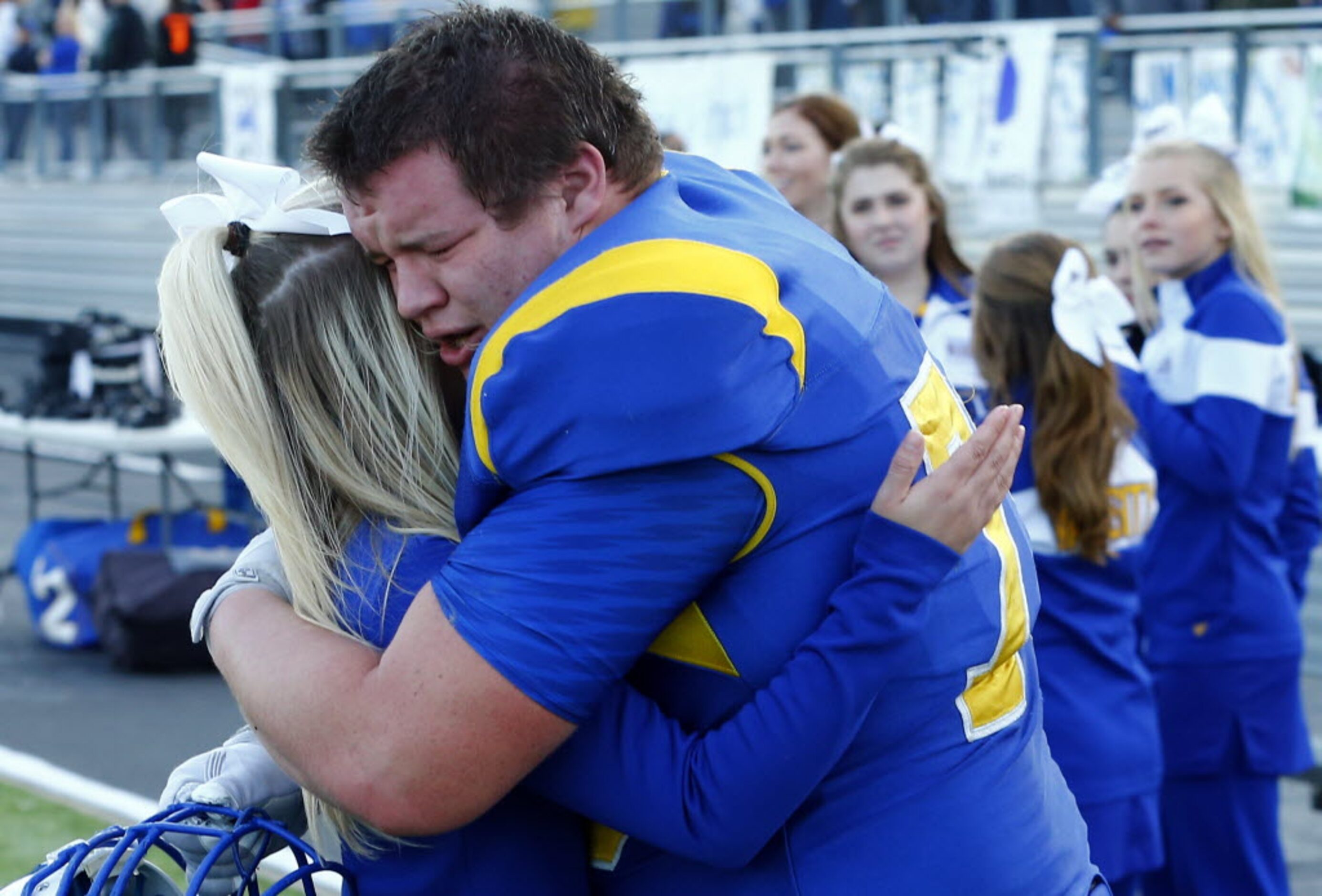 TXHSFB Sunnyvale cheerleader Gracyn Davis and Wade Cookston (79) embrace following their...