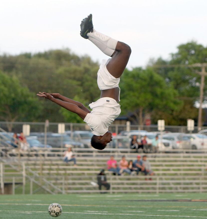 Dallas Hillcrest junior Yaya Dosso (9) flips in celebration of his second goal against...