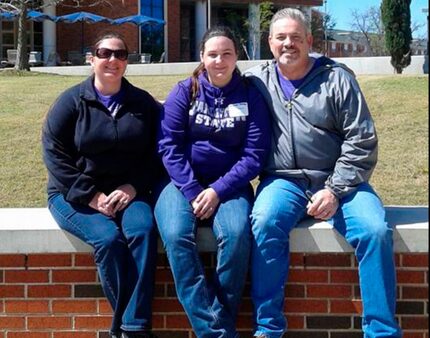 Jamie Richards, 19, center, with her parents.