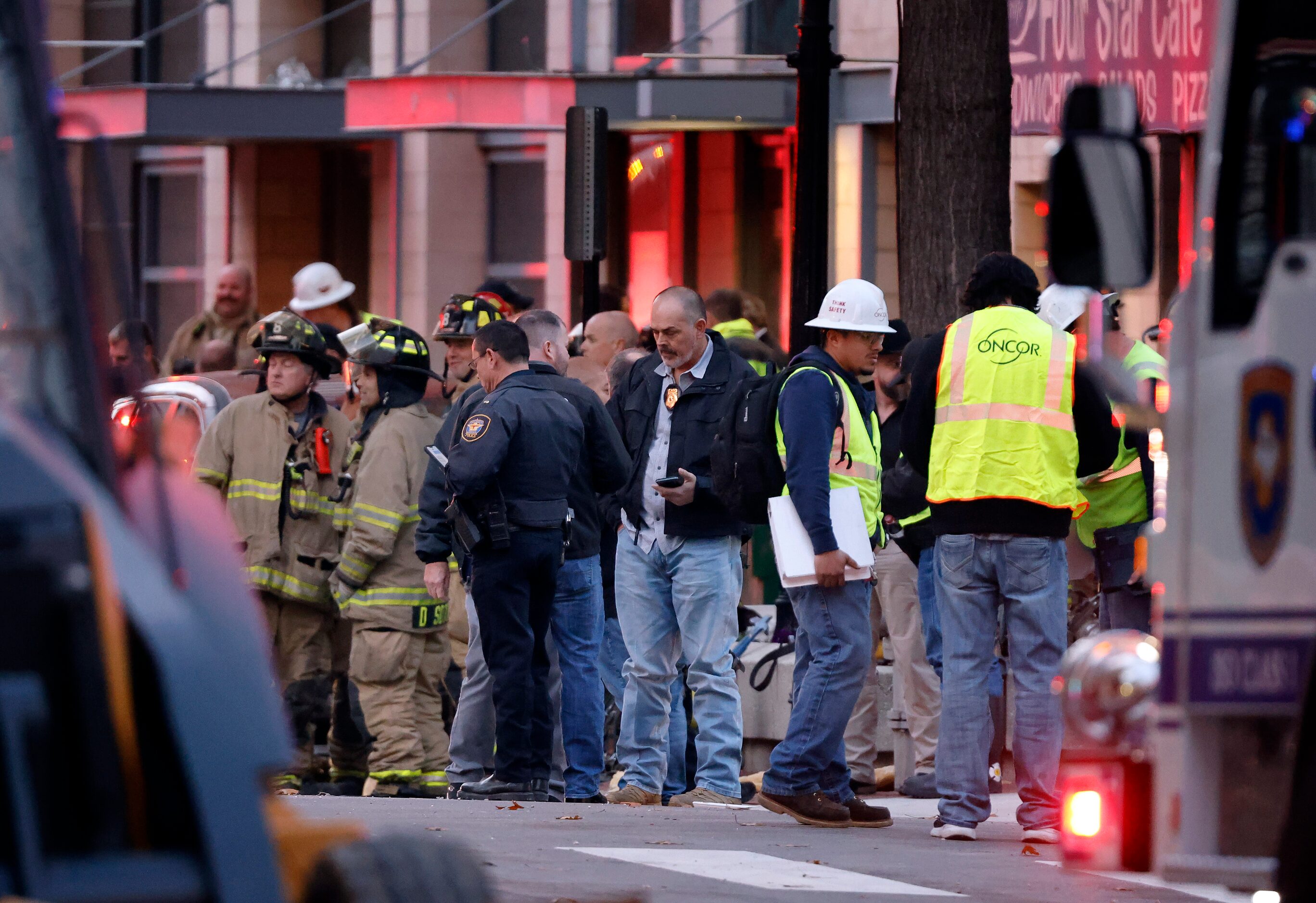 Officials gathered on Houston St. following an explosion that occurred at the Sandman...