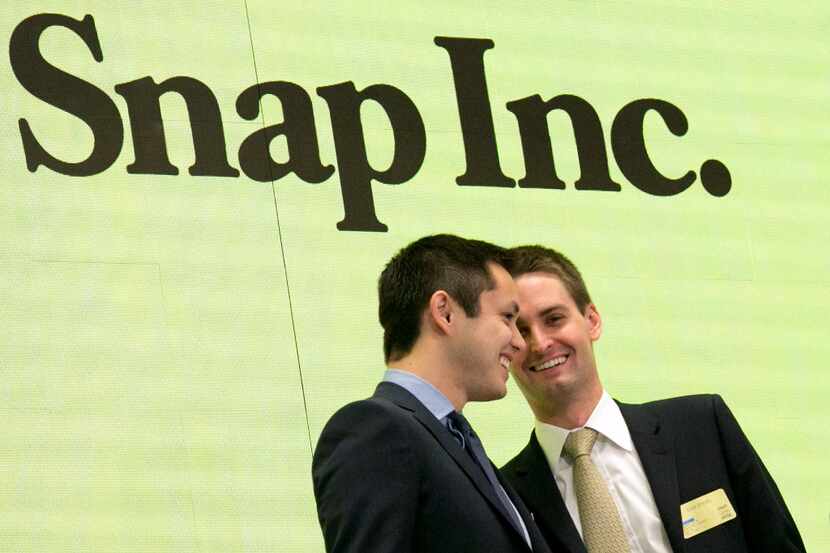 Snapchat co-founders Bobby Murphy, left, and CEO Evan Spiegel ring the opening bell at the...