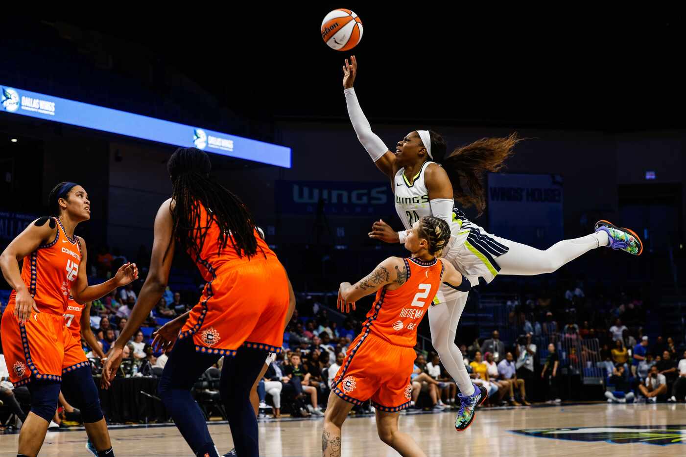 Dallas Wings guard Arike Ogunbowale (24) goes for a shot over Connecticut Sun guard Natisha...