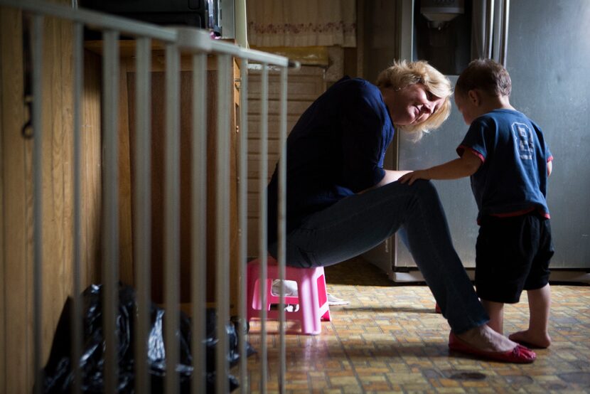 A Houston Child Protective Services caseworker talks to a 2-year-old boy who was found...