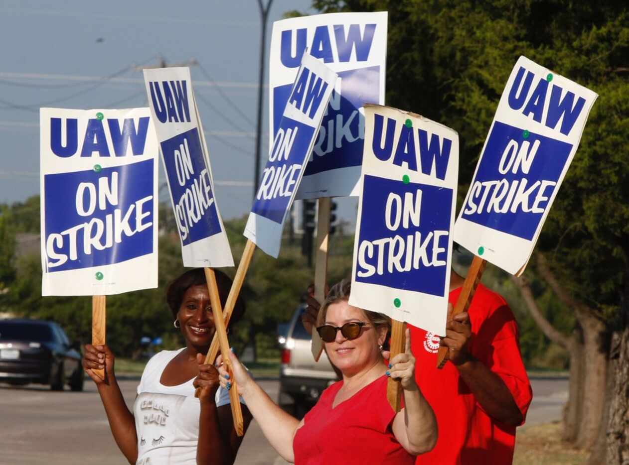 General Motors Assembly Plant workers walk the picket lines early Monday morning, September...