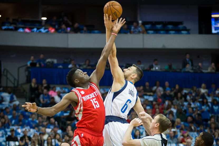 Dallas Mavericks center Andrew Bogut (6) goes for the opening tipoff against Houston Rockets...