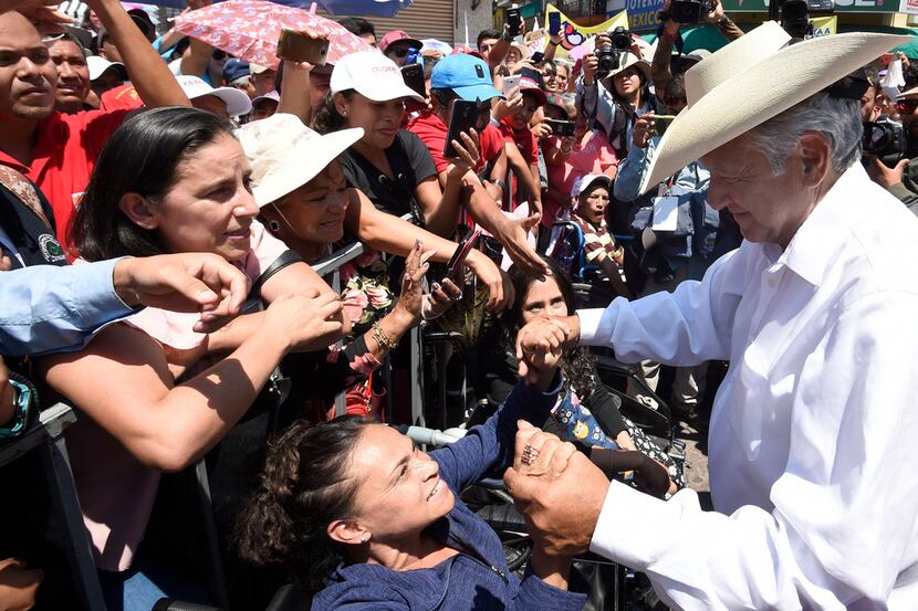 Mexican presidential candidate Andres Manuel Lopez Obrador greets supporters after a...