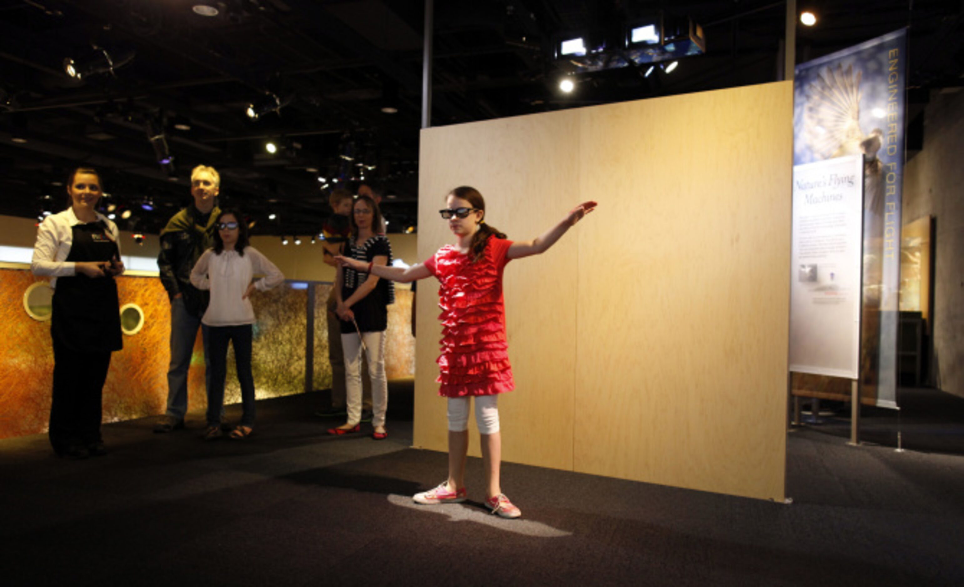 Alyssa Dendle, 10 of Dallas participates in an interactive flying exhibit in the Rose Hall...