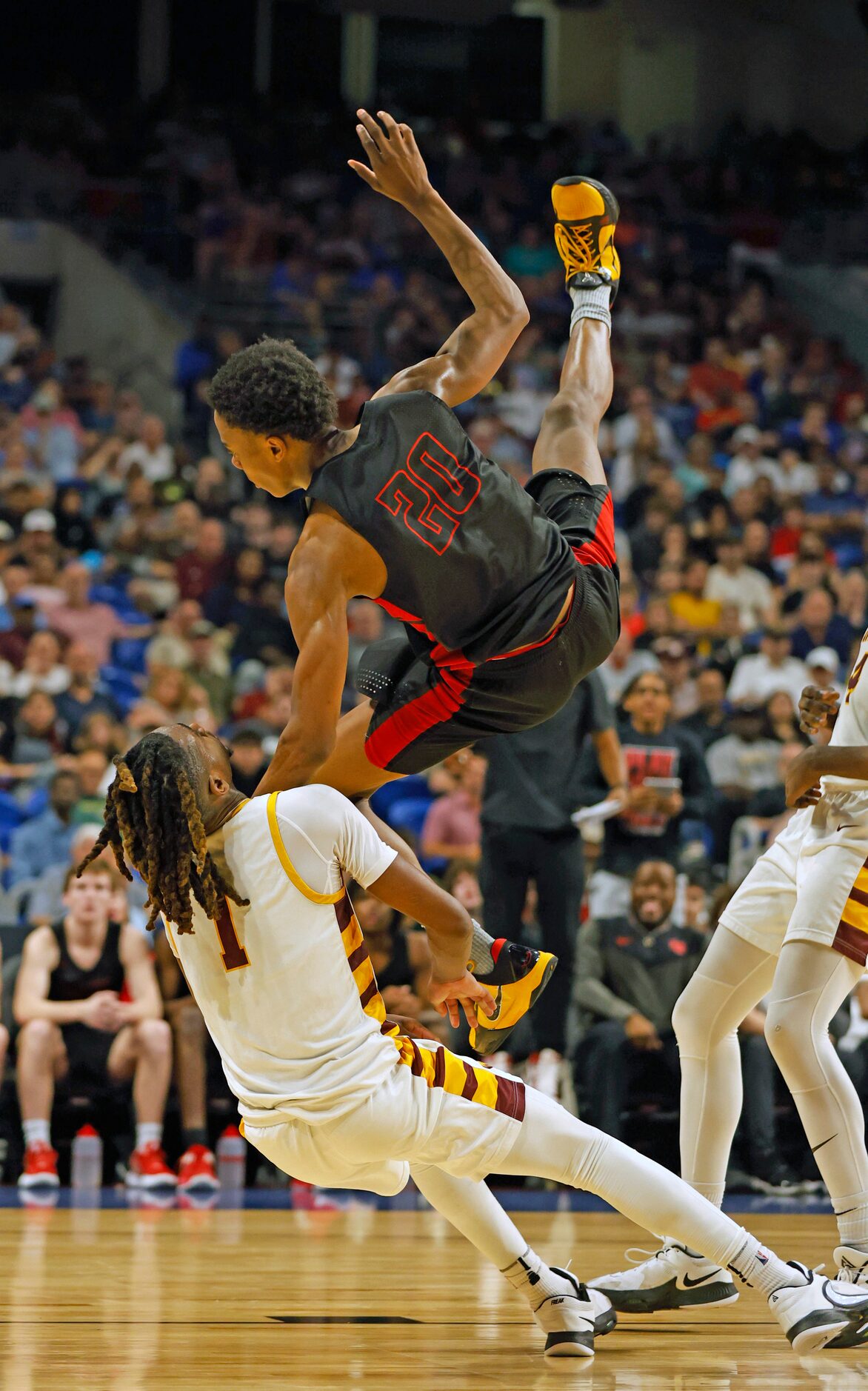 Lake Highlands Tre Johnson (20) is fouled by Beaumont United Daniel Williams (1). Lake...