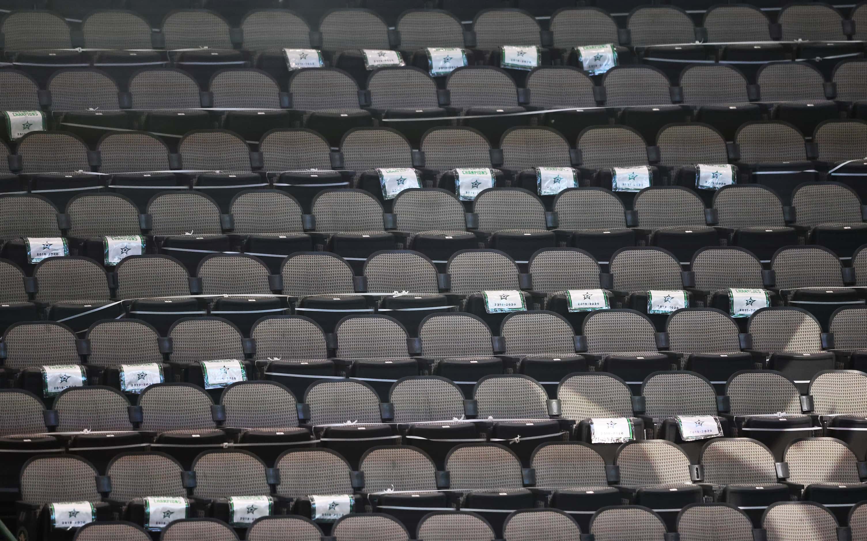 Seats safely distanced and marked with a replica banner prior to the start of a Dallas Stars...
