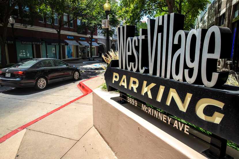 Cars enter the West Village shopping center parking lot in Dallas. The shopping center was...