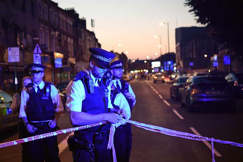  Police officers guard a road leading to Finsbury Park Mosque after an incident in which a...